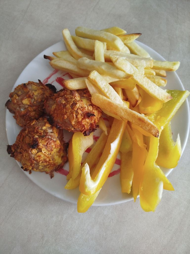 Tuna balls with fries and veggies. a quick meal to make